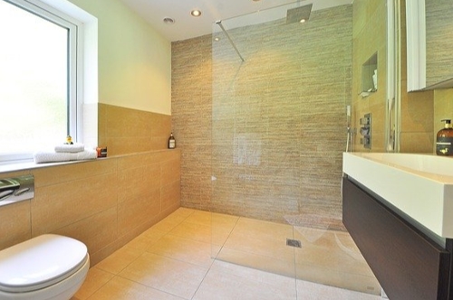bathroom with brown marble walls and floor